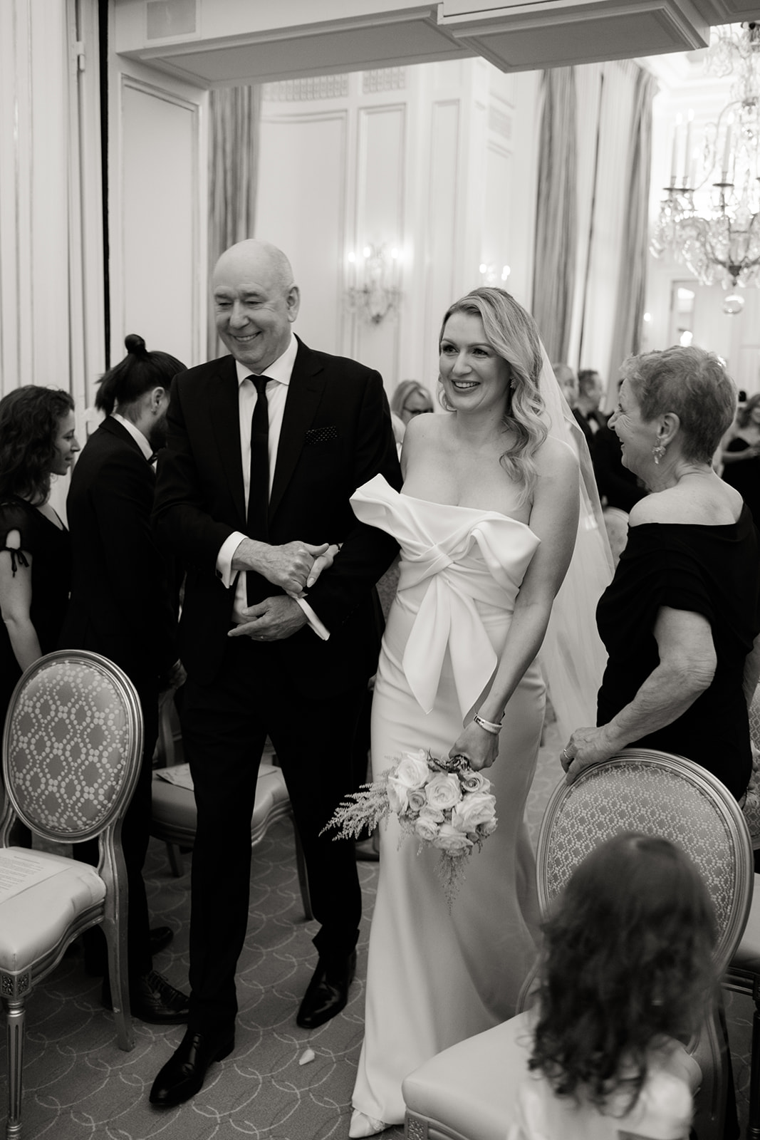 a couple the bride arrives at her ceremony at her father's barswork in paris